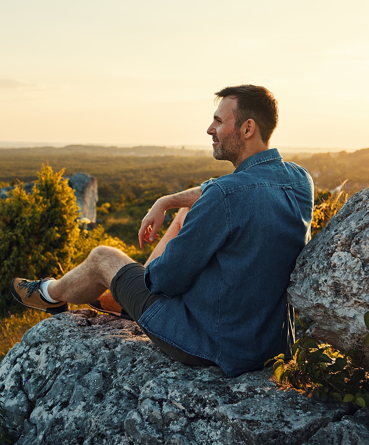 Man stretching outdoors with earbuds on.