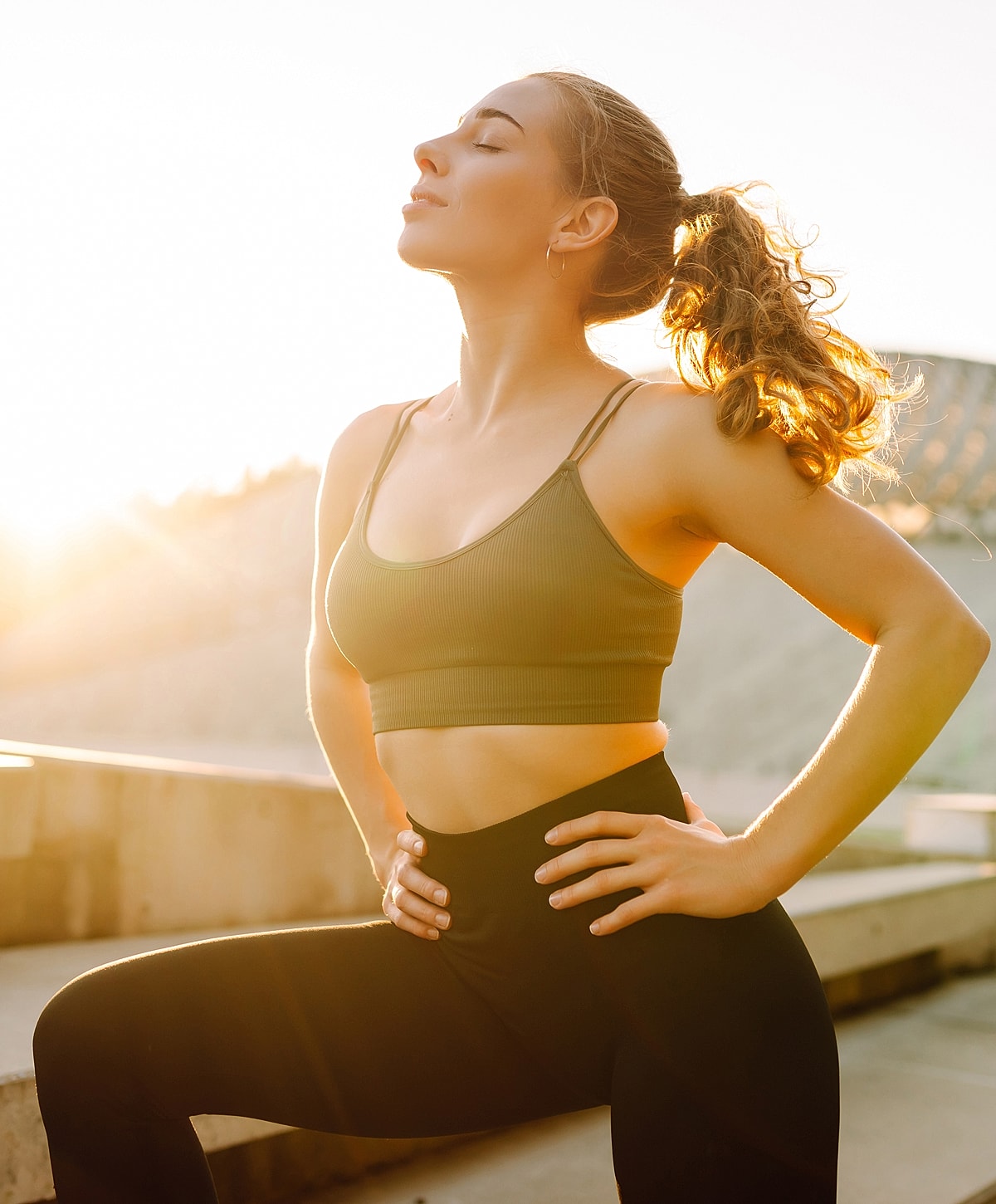 Woman practicing yoga in bright sunlight.