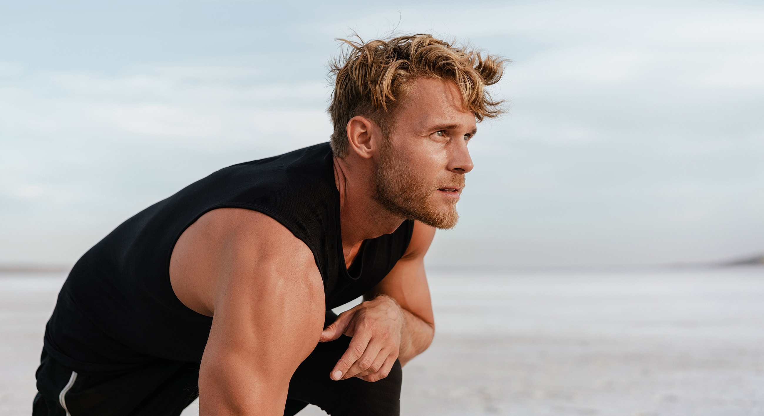 Athlete stretching in a scenic outdoor environment.