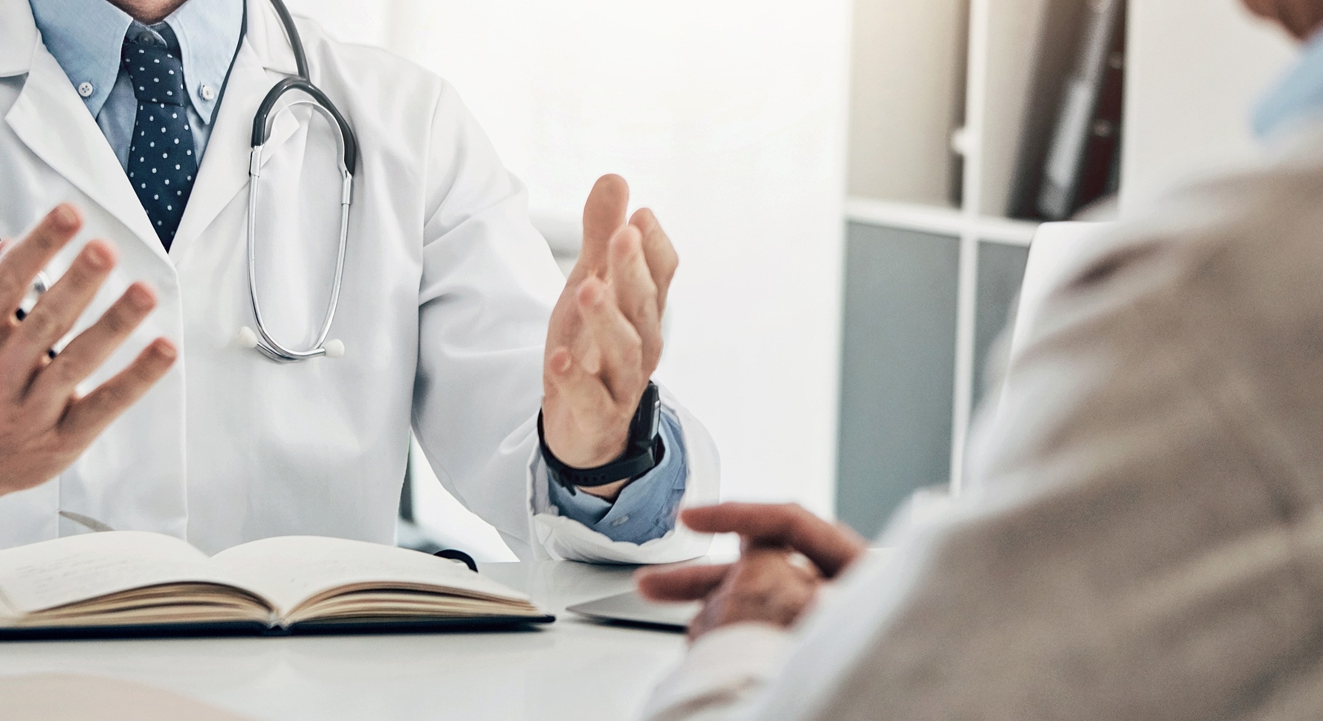 Doctor consulting with patient in medical setting.